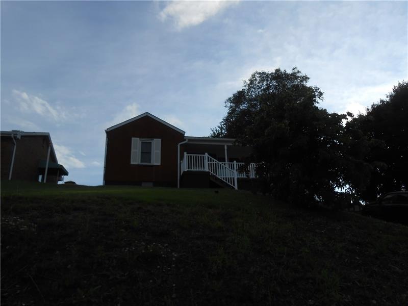 This all brick ranch, with it's neatly railed fron