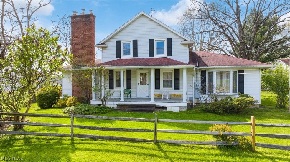 View of front of home with a front yard and a porch