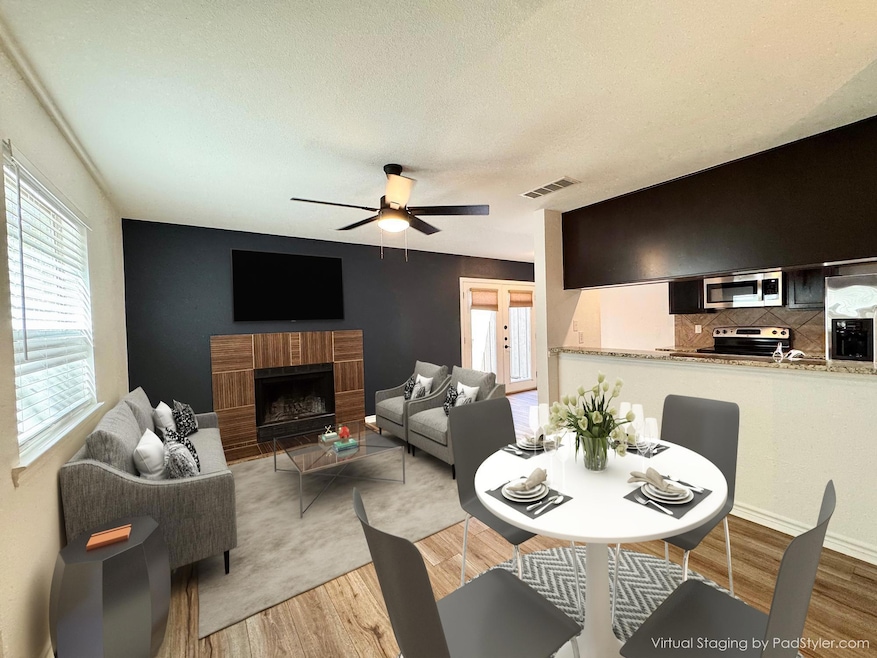 Dining area with ceiling fan, light wood-style fl
