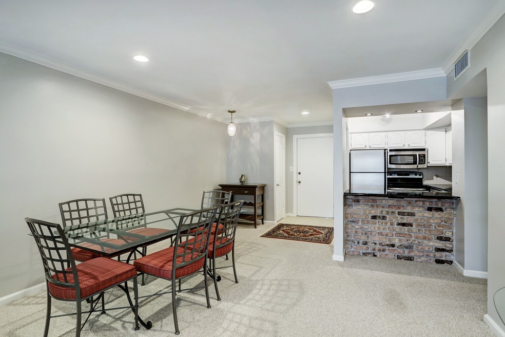 Spacious dining area with recessed lighting. Kitch