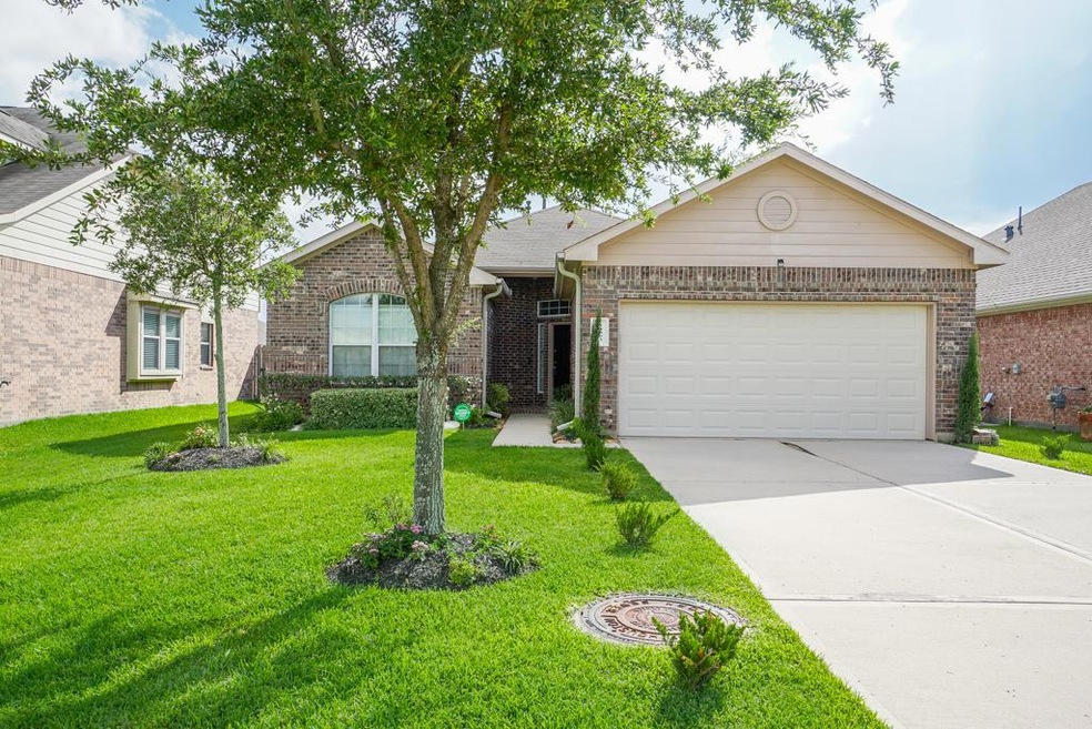 Beautiful brick facade and lush green grass add to the great curb appeal.