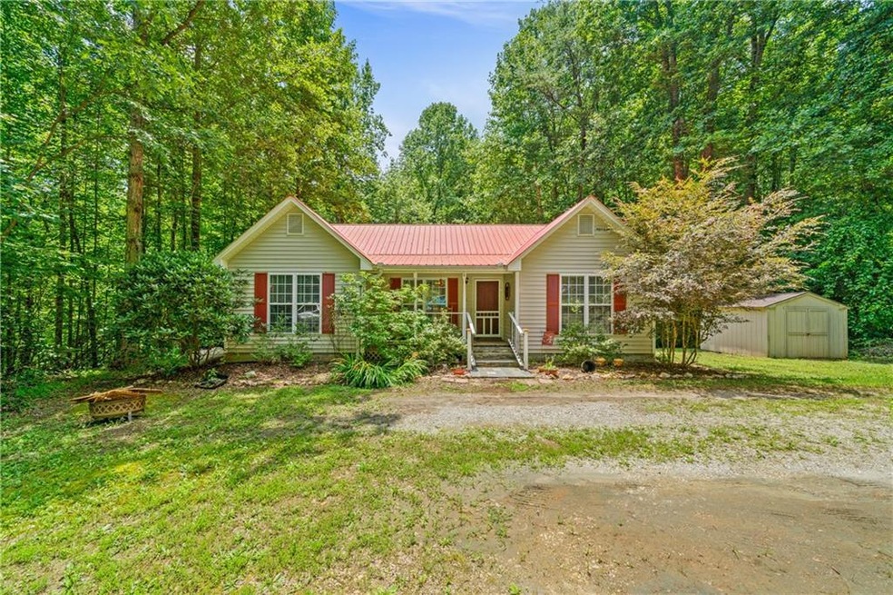 View of front of property with a storage shed and 