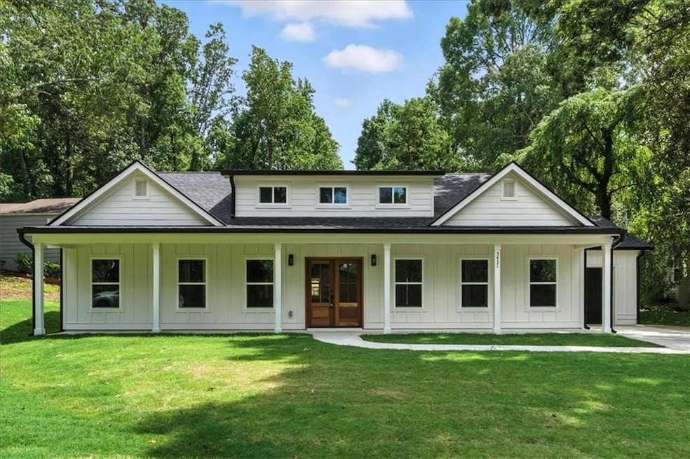 View of front facade featuring board and batten siding, roof with shingles, french doors, and covered porch