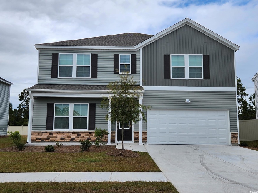 View of front of property featuring a garage