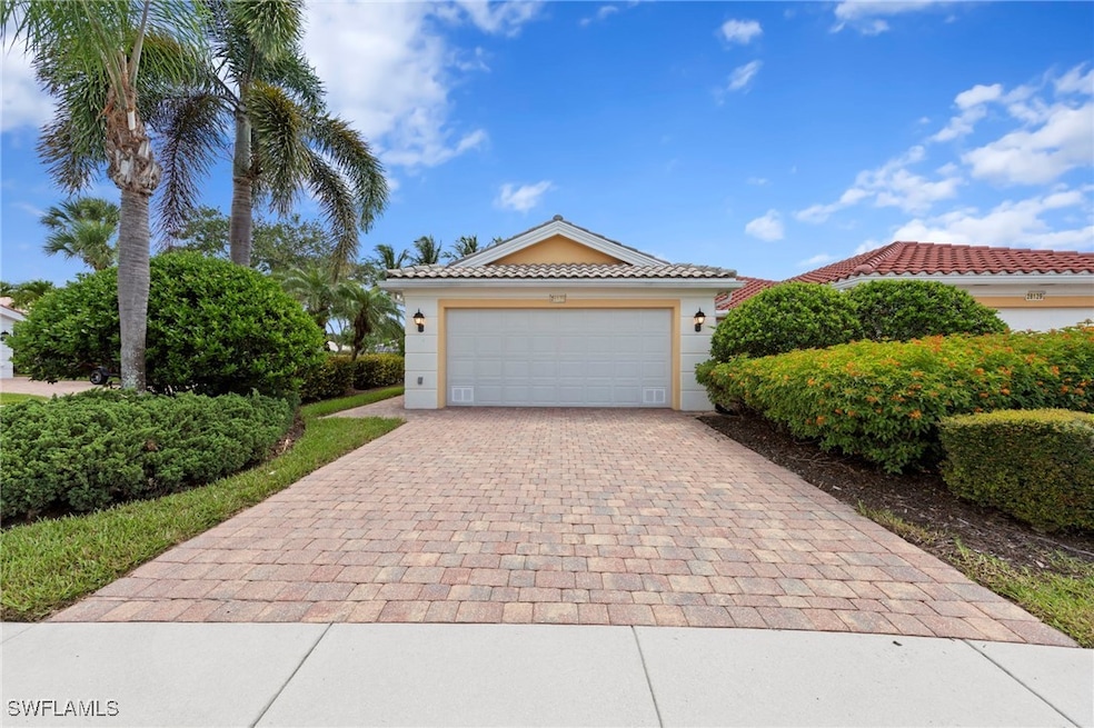 View of front of house with decorative driveway, s