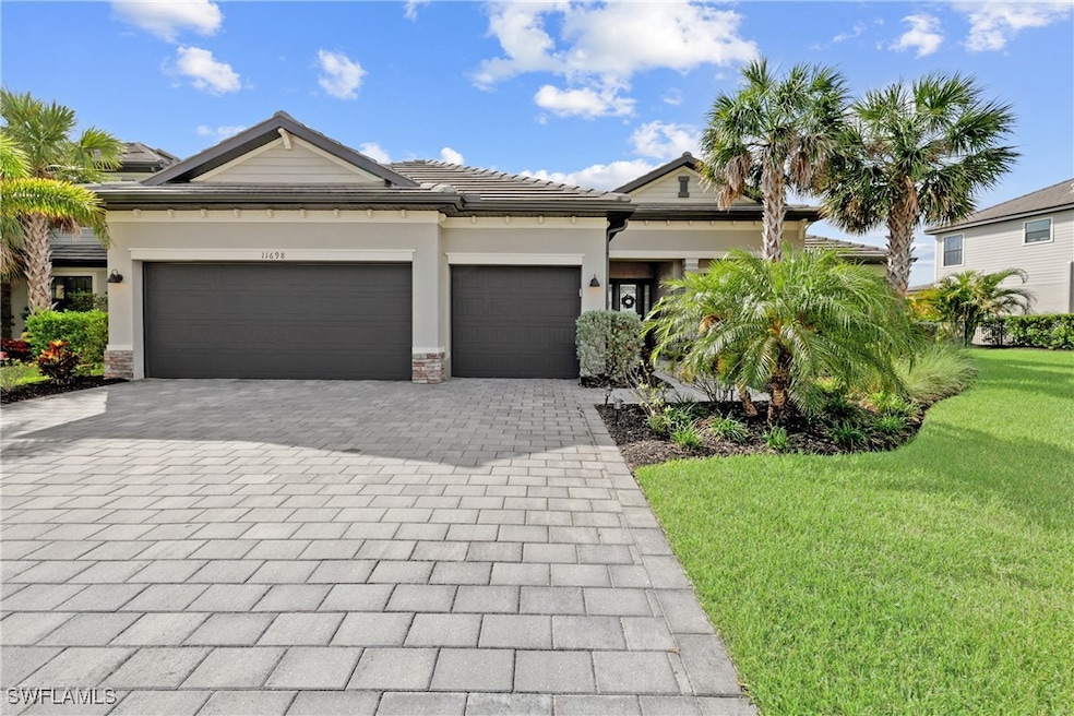 View of front of home with decorative driveway, a