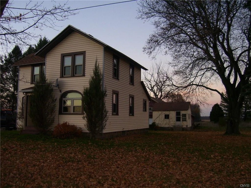 Front and side of house with view of small bldg. a