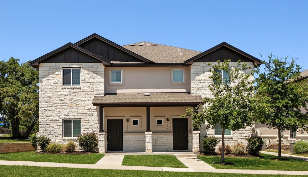 Craftsman house featuring roof with shingles, sto