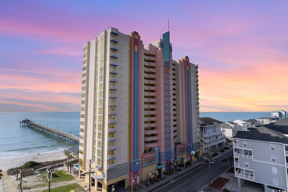 View of property featuring a beach view and a wate