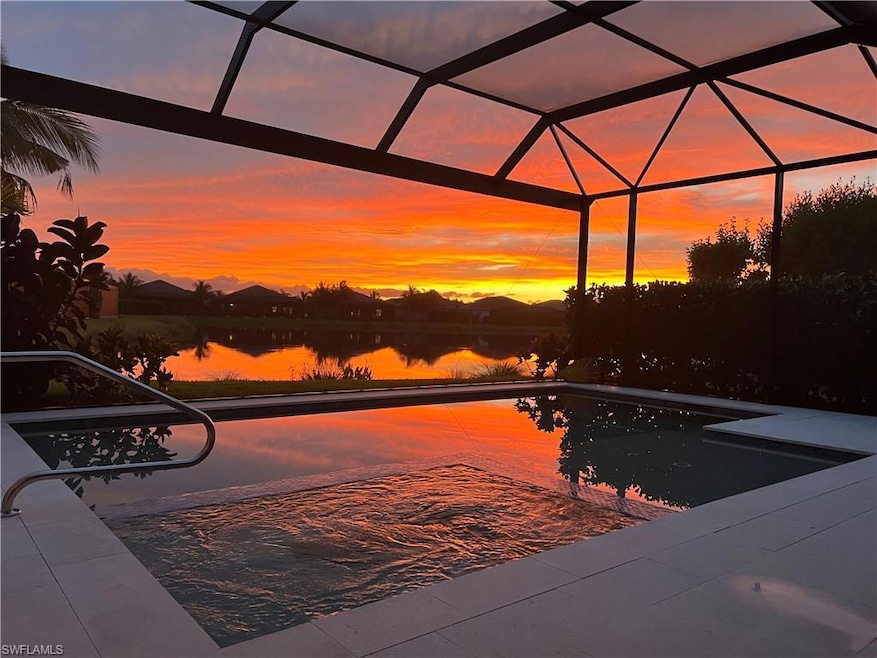 Pool at dusk featuring an outdoor pool, a water vi