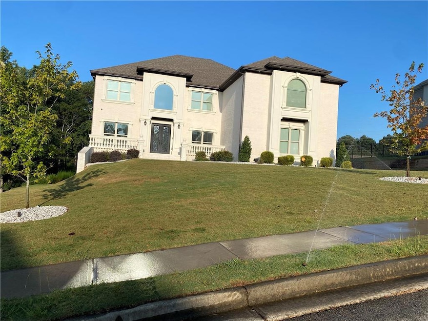 View of front of property featuring a front lawn and stucco siding