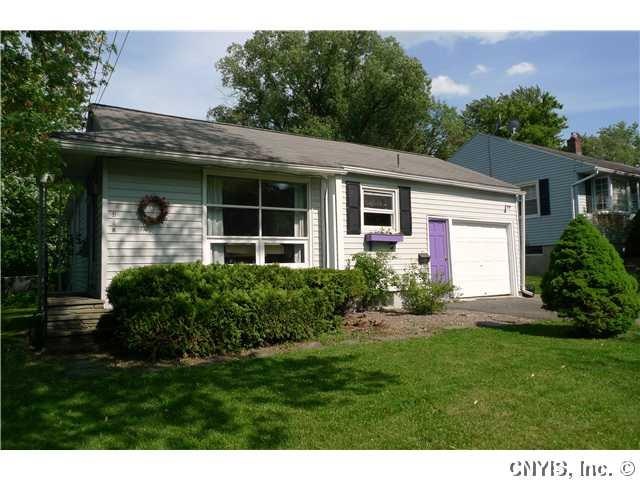 Exterior Front. Flat ranch with attached one car g
