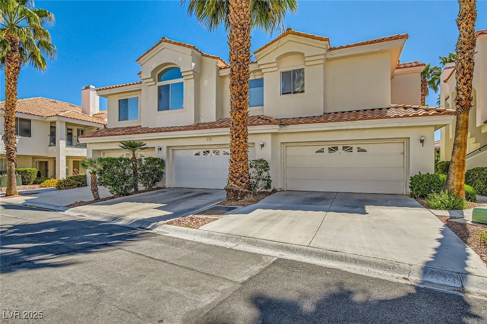 View of front of home with a garage, stucco siding