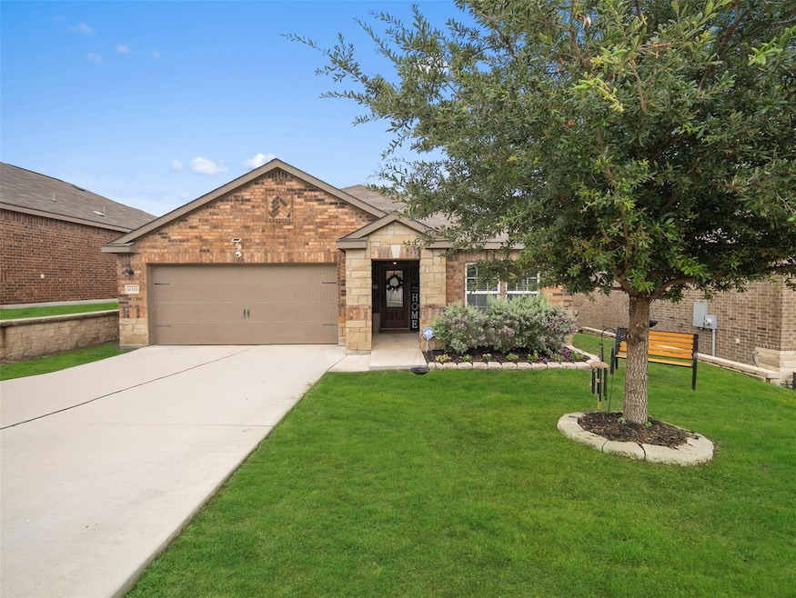 Ranch-style house featuring a garage, driveway, a