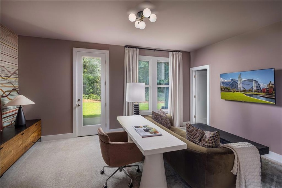 Carpeted home office with baseboards