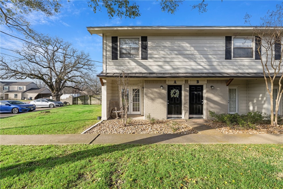 Townhome / multi-family property with a front yard