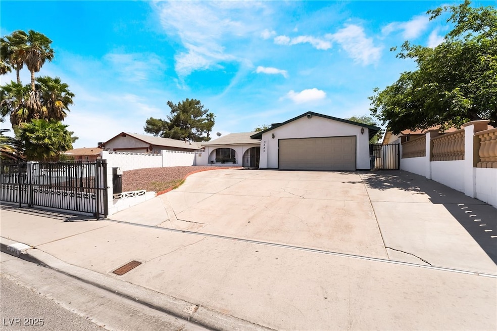 Ranch-style house featuring a gate, stucco siding,
