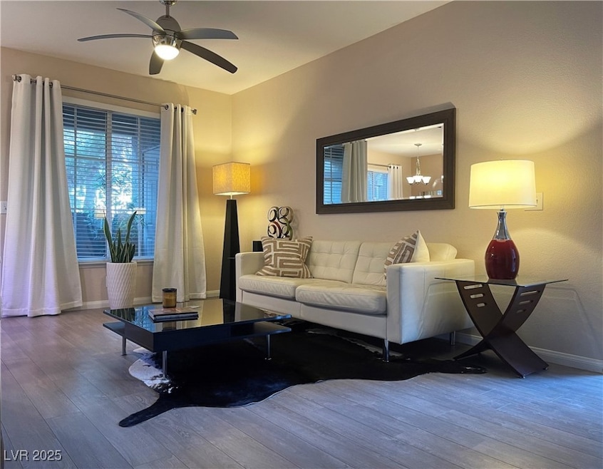 Living room featuring wood finished floors and a ceiling fan