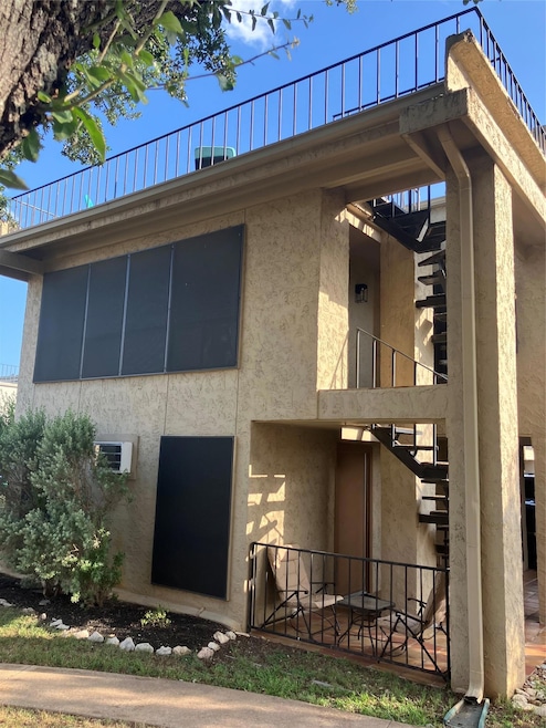 View of side of property featuring stucco siding 