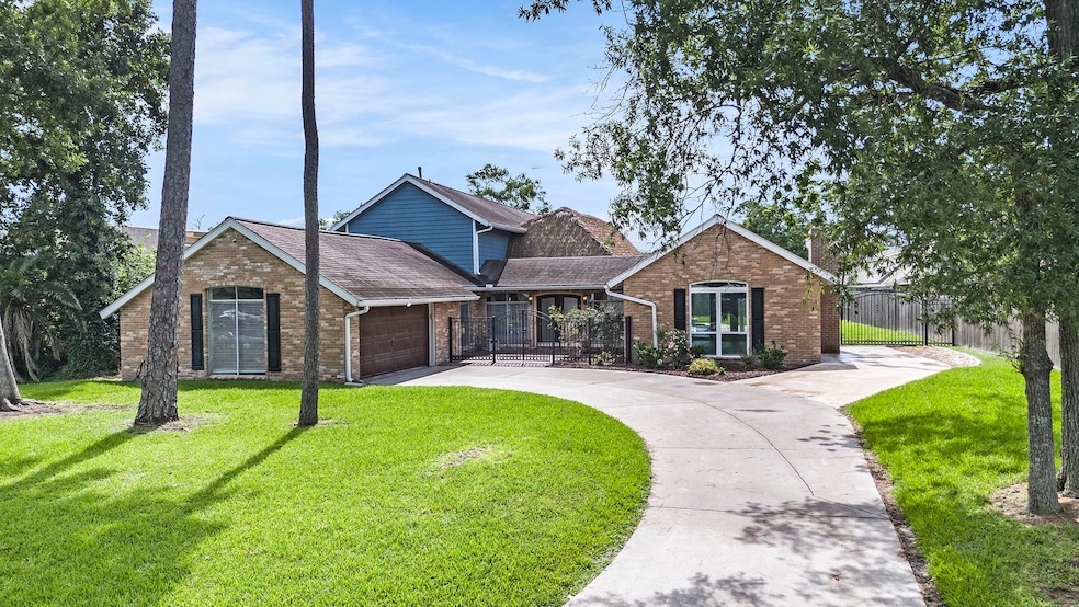 Charming front view with a lush lawn, mature trees