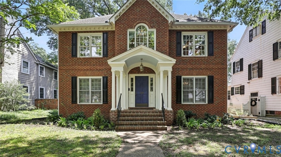 Colonial-style house with brick siding