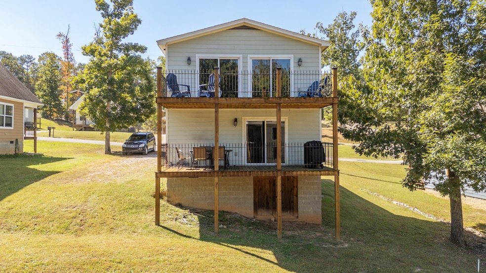 Back of property with a lawn