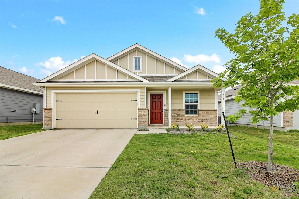 Craftsman-style home with a garage, a front yard, 
