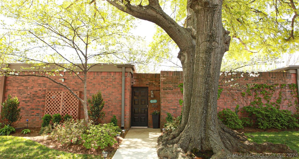 Gorgeous full brick entrance with nice shade tree