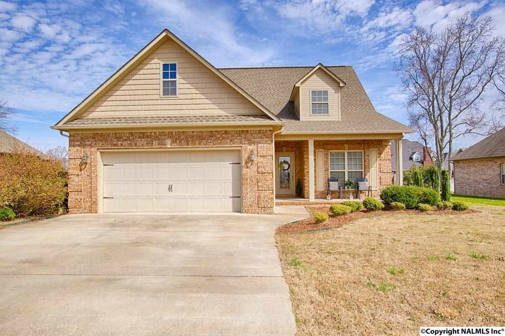 Custom built home with keystone detail above the garage, front door and window along with quoin corners in the brick detail.