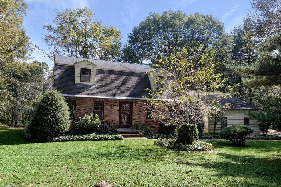 Nestled behind the tree's this home cannot be seen