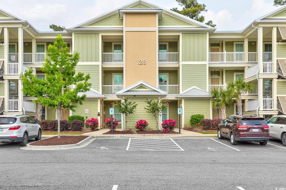 View of property with uncovered parking
