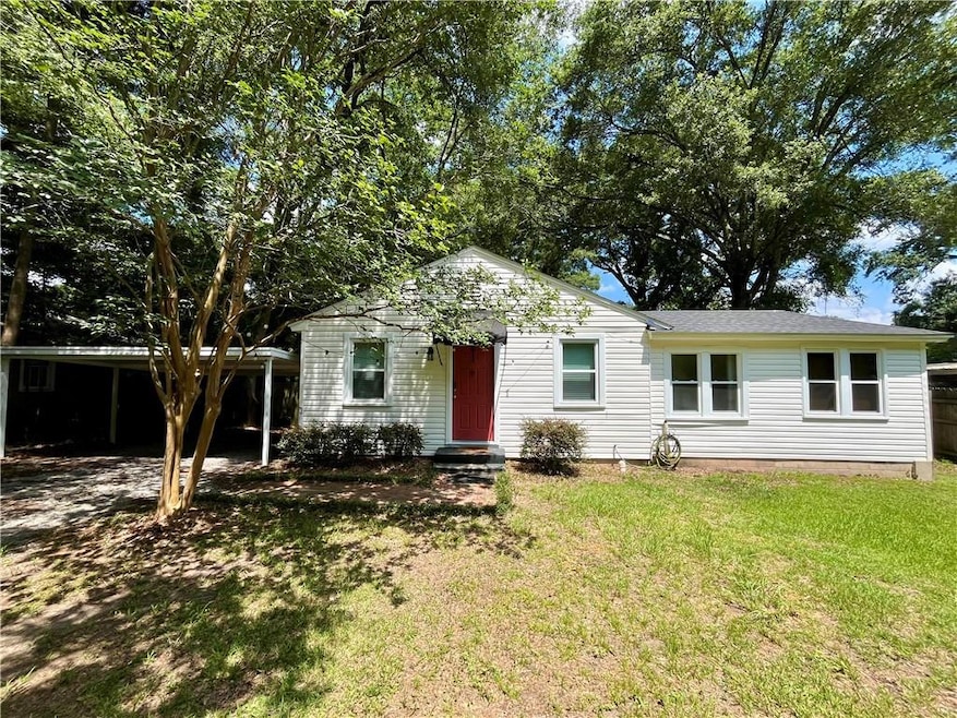 View of front of house featuring a carport and a f