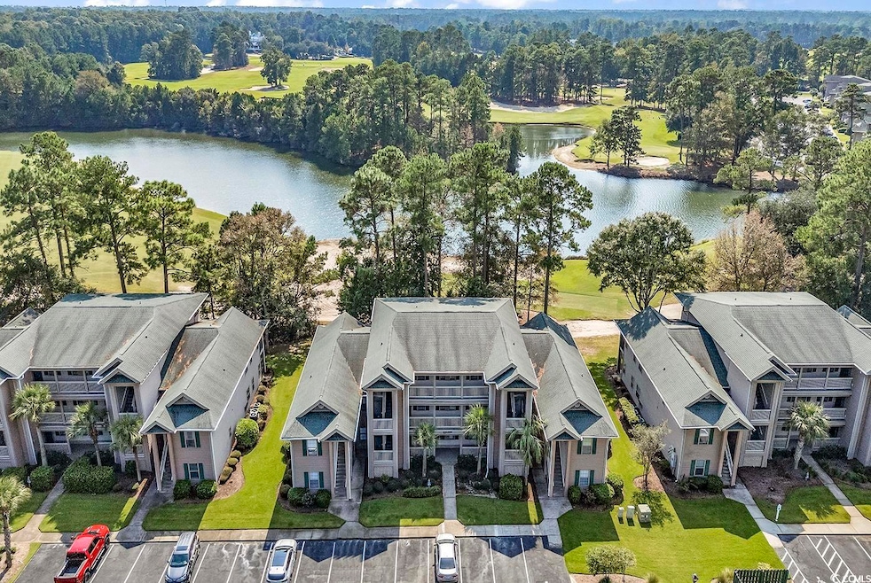 Birds eye view of property with a water view