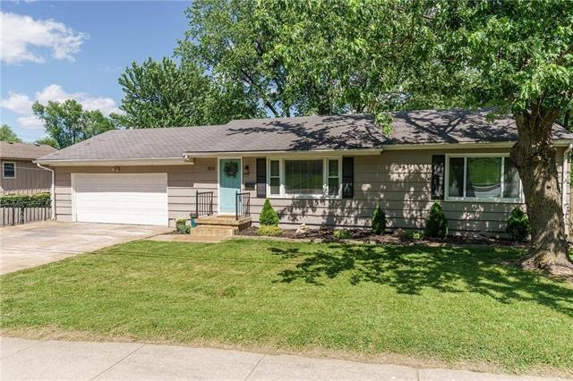 This ranch boasts a large driveway with a spacious
