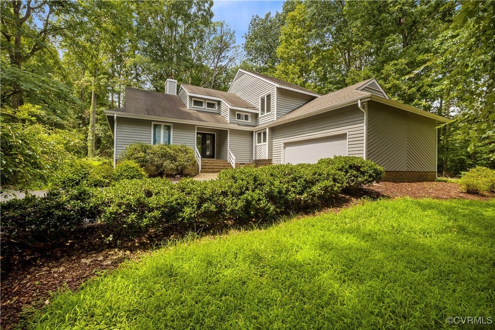 View of property featuring a garage and a front la