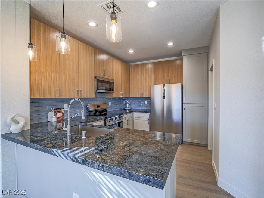 Kitchen featuring appliances with stainless steel