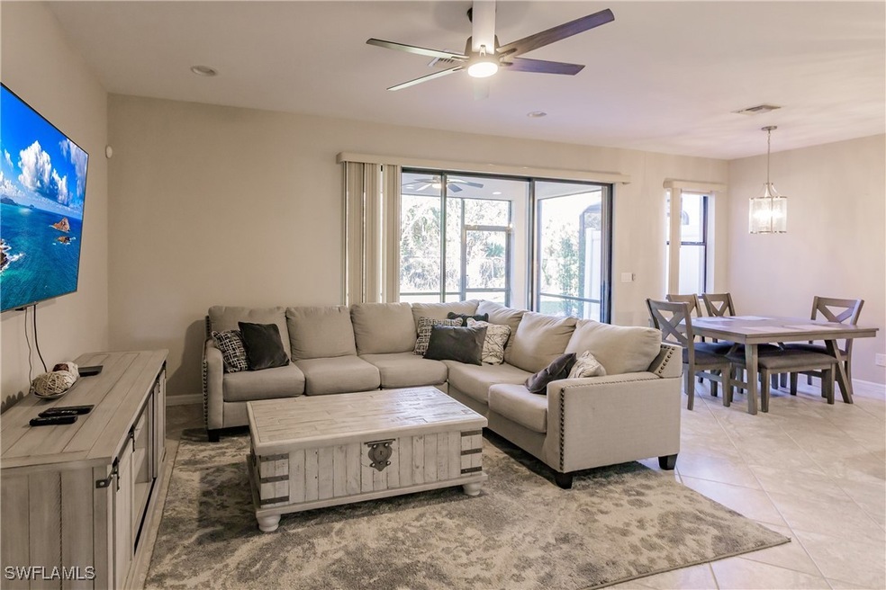 Tiled living room with a notable chandelier