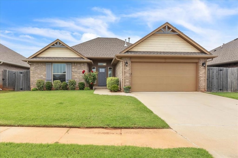 View of front of home with brick siding, an attached garage, concrete driveway, and roof with shingles
