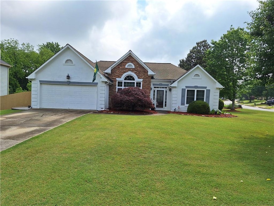 View of front of home with fence, a shingled roof,