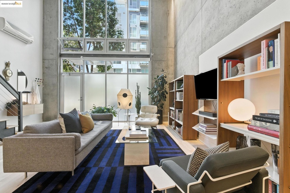 Living room featuring a high ceiling and a wall mounted AC