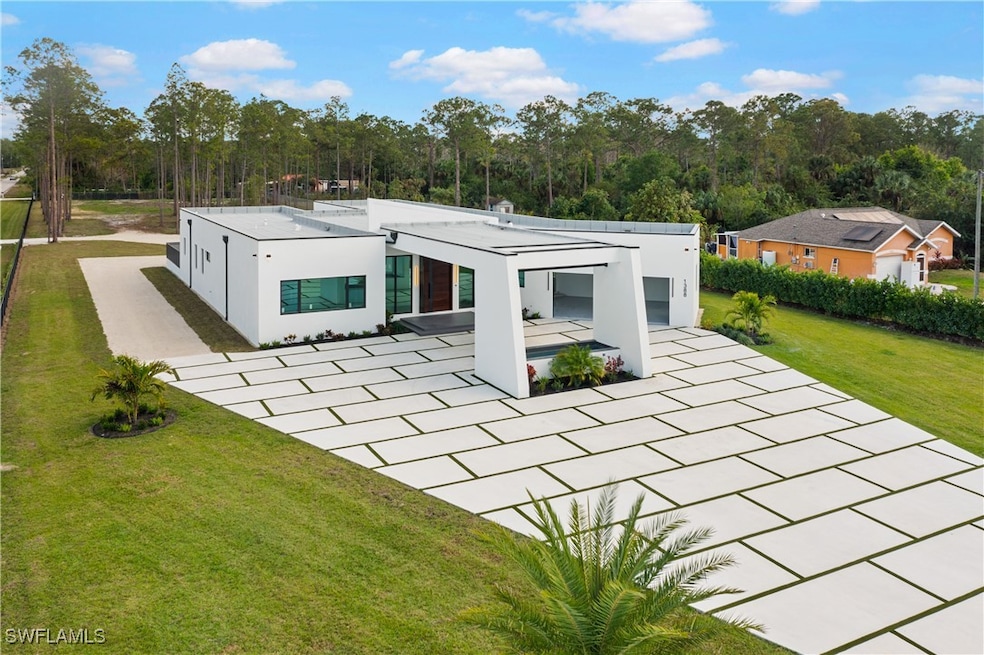 Rear view of property with a patio area and a lawn