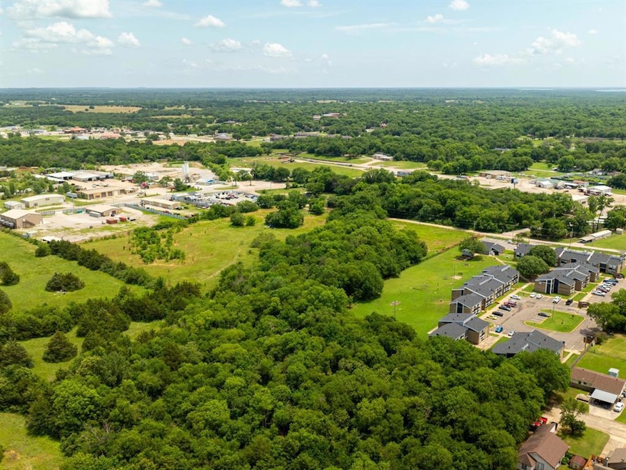 Aerial perspective of suburban area featuring a forest