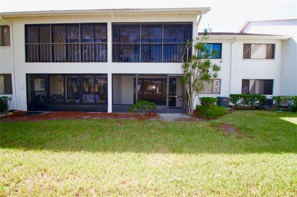 View of the back of the condominium unit with scre