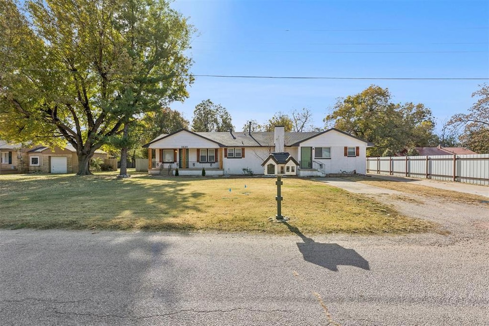 Single story home featuring a chimney and driveway