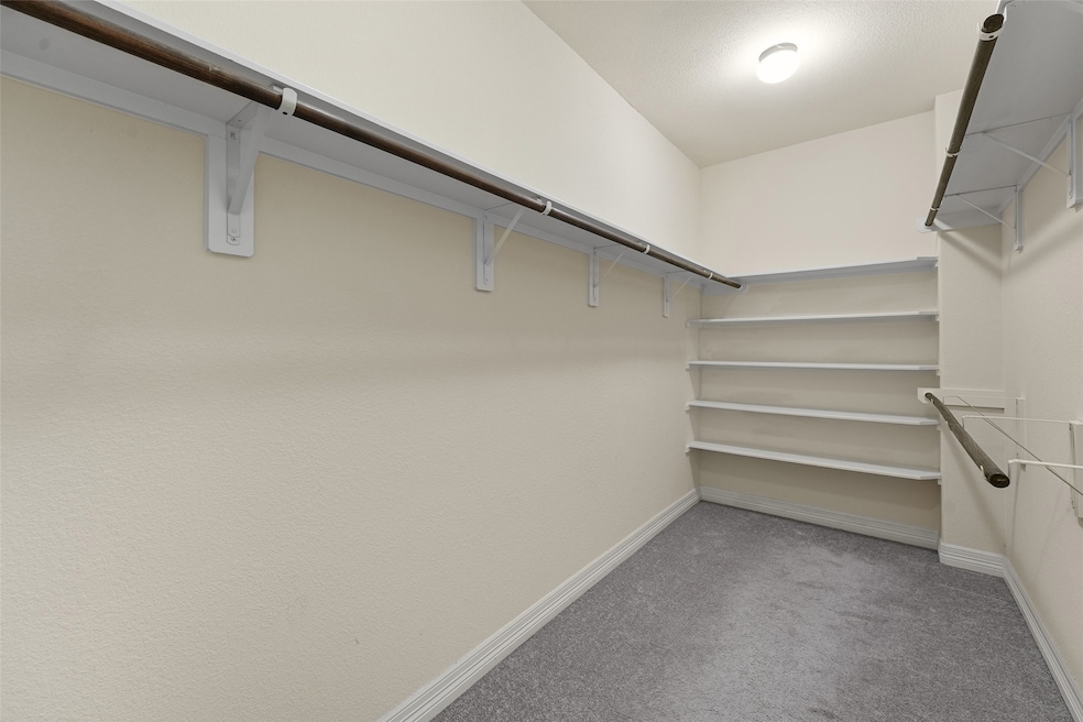 View of the walk in closet located in the primary
