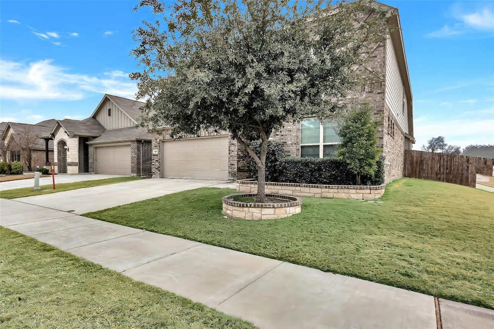View of front of home with a garage and a front la