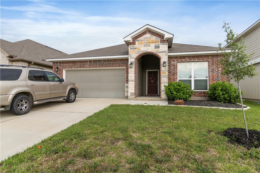 View of front of home with a front lawn, stone sid