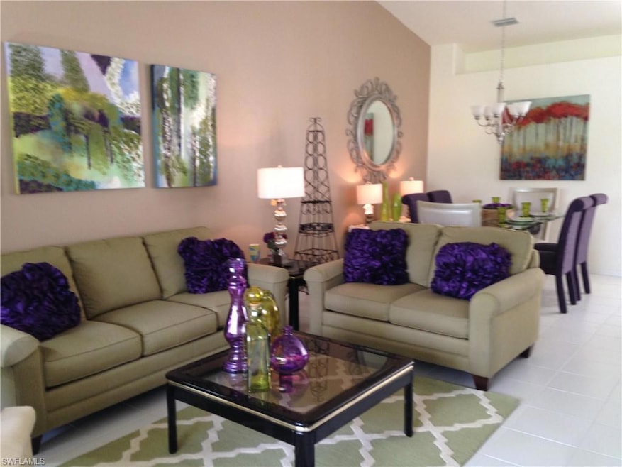 Living area with vaulted ceiling, light tile patte