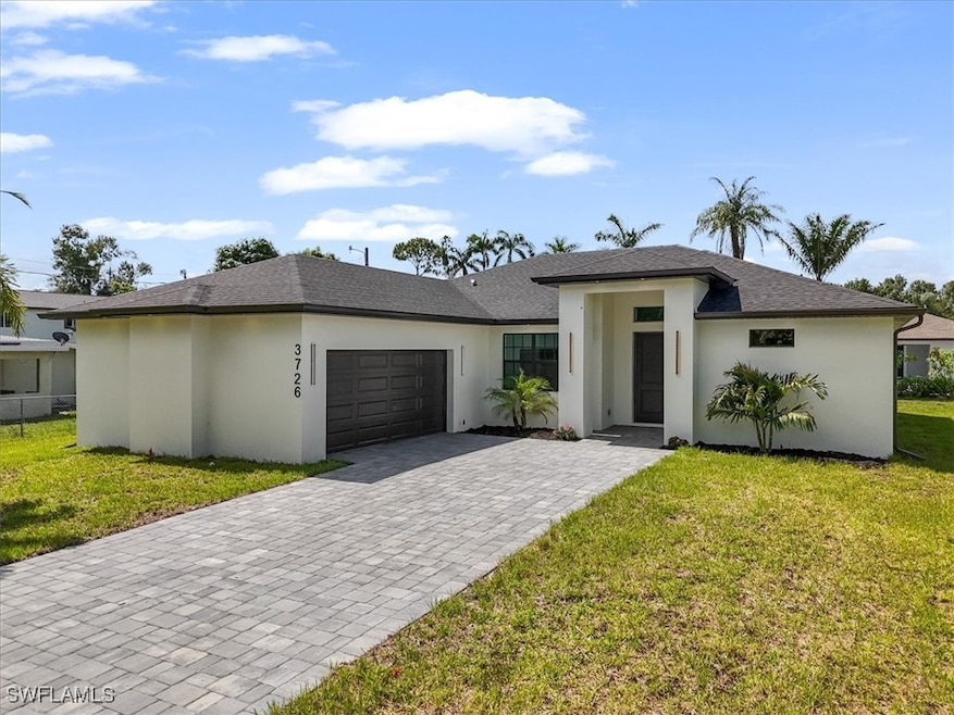 Prairie-style home with a garage, decorative drive