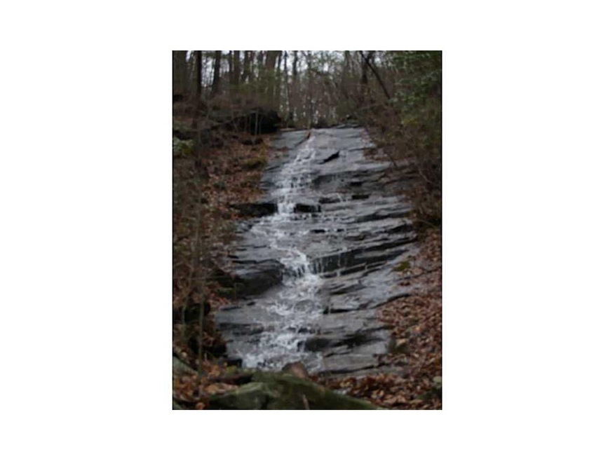 Exterior Front. VIEW OF WATERFALL FROM PROPERTY